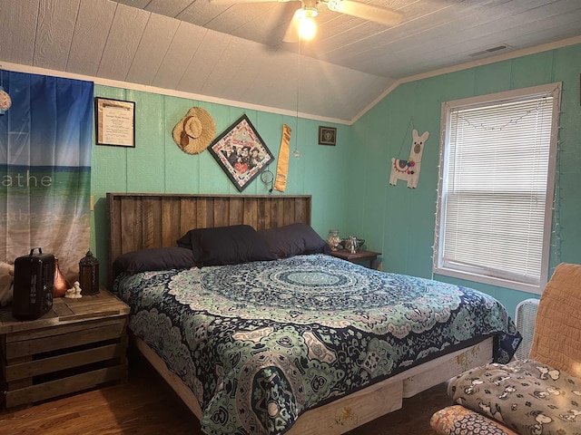 bedroom with wood-type flooring, vaulted ceiling, ceiling fan, and ornamental molding