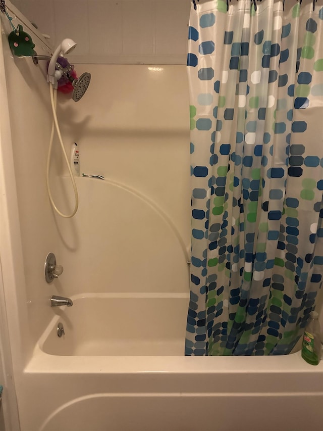 bathroom with shower / bathtub combination with curtain