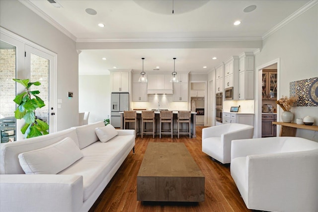 living room featuring dark hardwood / wood-style flooring and ornamental molding