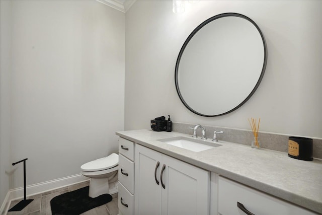 bathroom with tile patterned floors, vanity, toilet, and ornamental molding