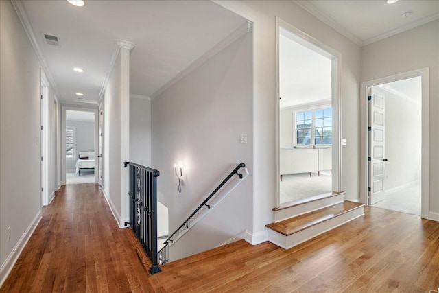 hall featuring wood-type flooring and ornamental molding