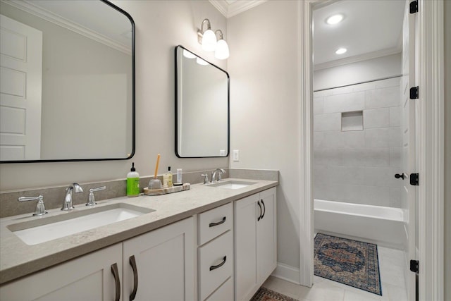 bathroom featuring tile patterned floors, crown molding, vanity, and tiled shower / bath combo