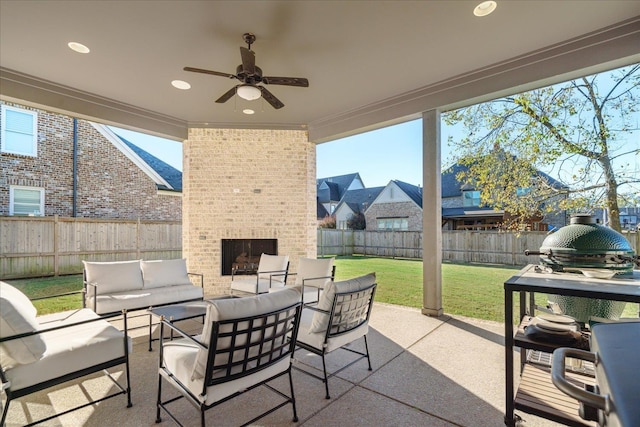 view of patio featuring an outdoor living space with a fireplace and ceiling fan