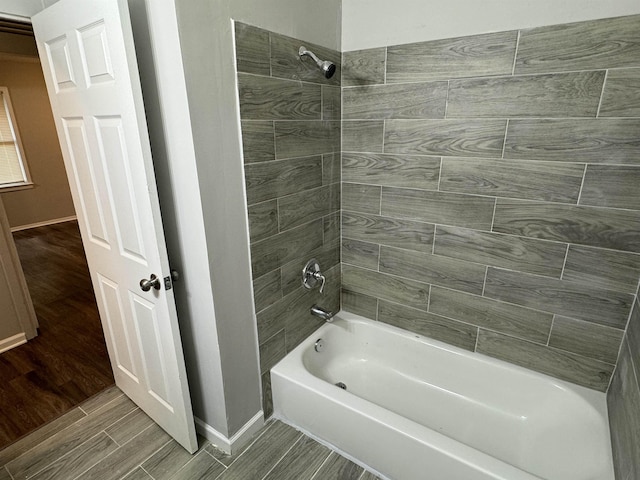 bathroom featuring hardwood / wood-style floors and tiled shower / bath