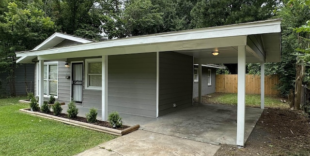 view of outbuilding featuring a carport and a lawn