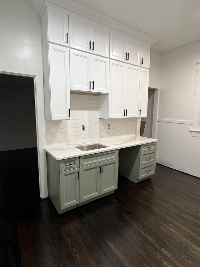 kitchen with white cabinetry, decorative backsplash, dark hardwood / wood-style flooring, and sink