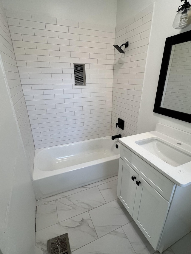 bathroom featuring tiled shower / bath combo and vanity