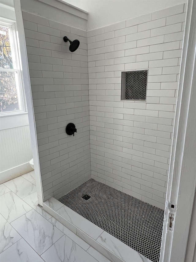 bathroom with tiled shower