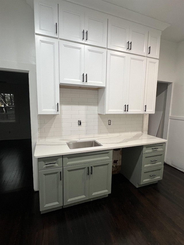 kitchen with backsplash, white cabinetry, sink, and dark hardwood / wood-style floors