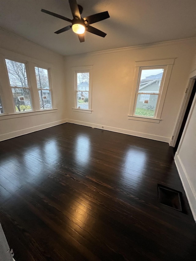 unfurnished room with dark hardwood / wood-style floors and ceiling fan