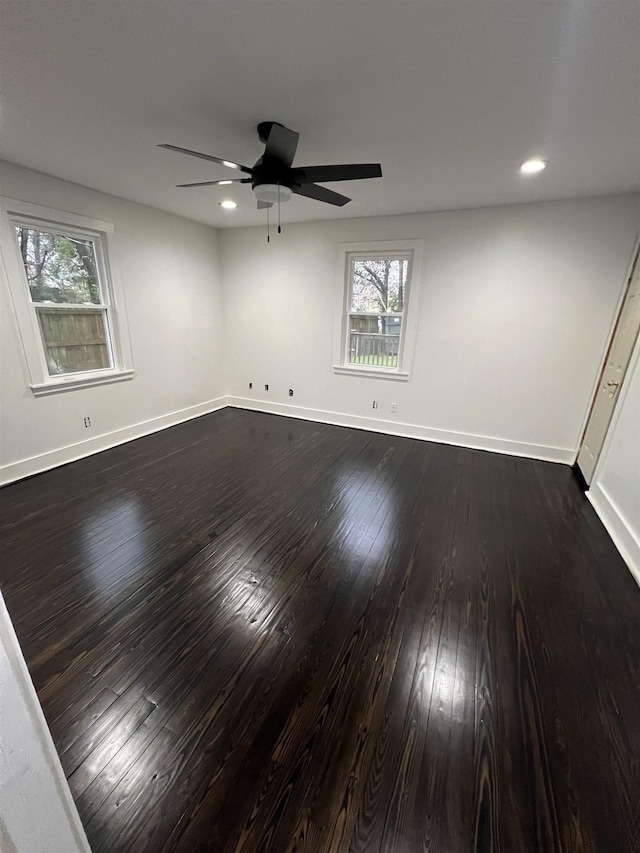 unfurnished room featuring ceiling fan and dark hardwood / wood-style flooring