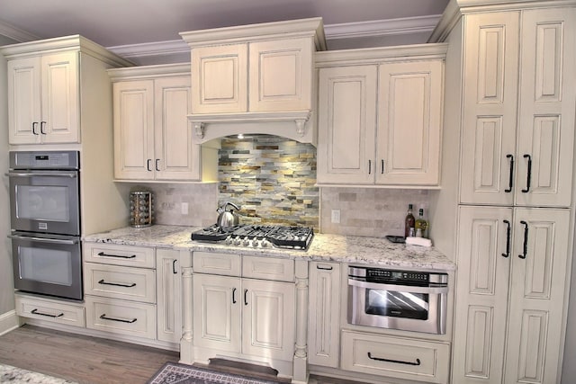 595 Kenrose St, Collierville, TN 38017 - kitchen with stainless steel appliances, crown molding, light stone counters, and decorative backsplash