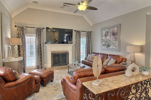 living room with crown molding, a fireplace, and vaulted ceiling