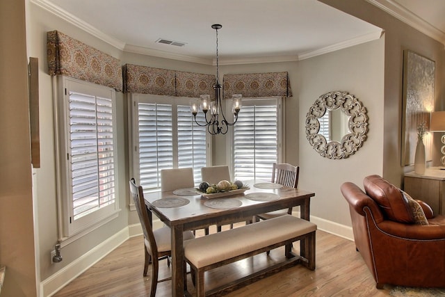 595 Kenrose St, Collierville, TN 38017 - dining room with a chandelier, light wood-type flooring, and ornamental molding