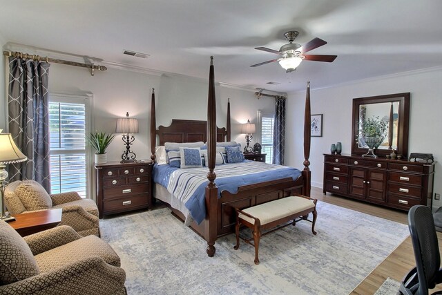 bedroom featuring ceiling fan, light hardwood / wood-style flooring, and ornamental molding