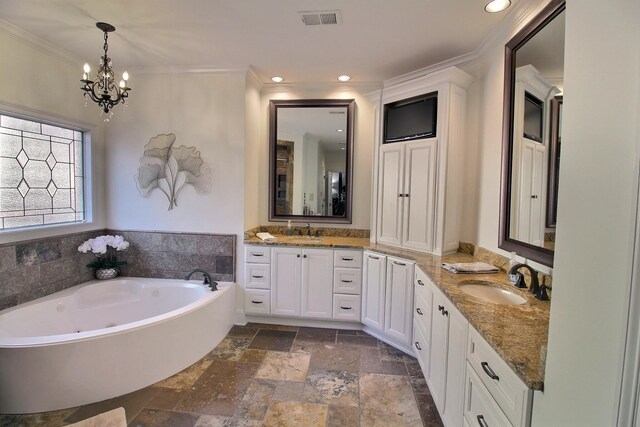 bathroom with a bathing tub, vanity, an inviting chandelier, and crown molding