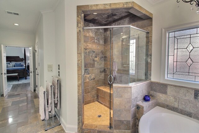 bathroom featuring ornamental molding, shower with separate bathtub, and a wealth of natural light