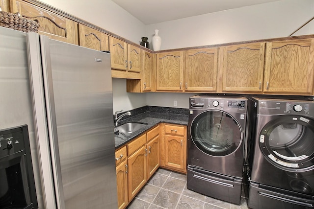 595 Kenrose St, Collierville, TN 38017 - laundry area featuring washer and clothes dryer, light stone finish flooring, and cabinet space