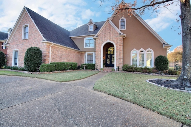 view of property featuring a front lawn