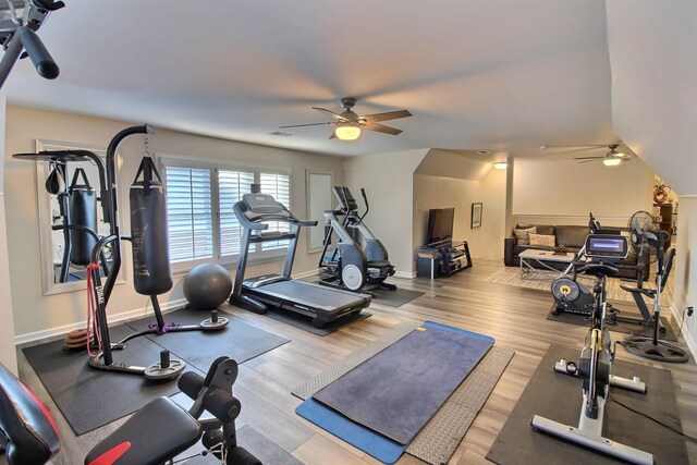 workout room featuring ceiling fan and light hardwood / wood-style flooring