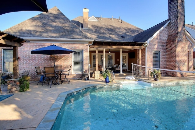 595 Kenrose St, Collierville, TN 38017 - back of house with a chimney, brick siding, a shingled roof, a patio area, and an outdoor pool