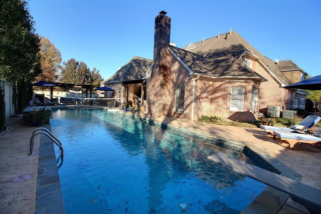 view of pool featuring a patio area and cooling unit