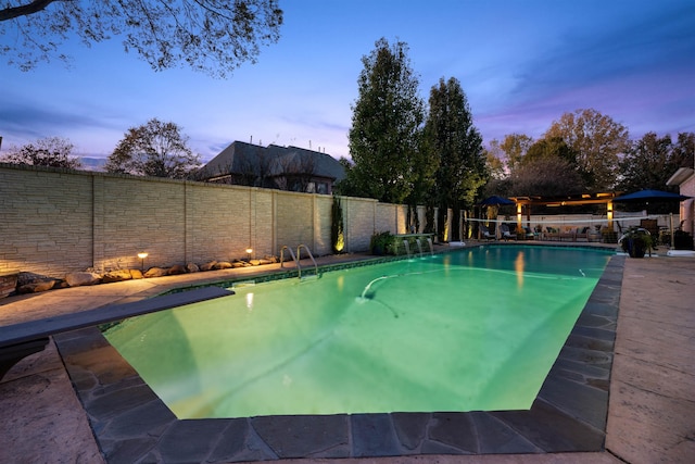 595 Kenrose St, Collierville, TN 38017 - pool at dusk featuring a fenced backyard and a diving board