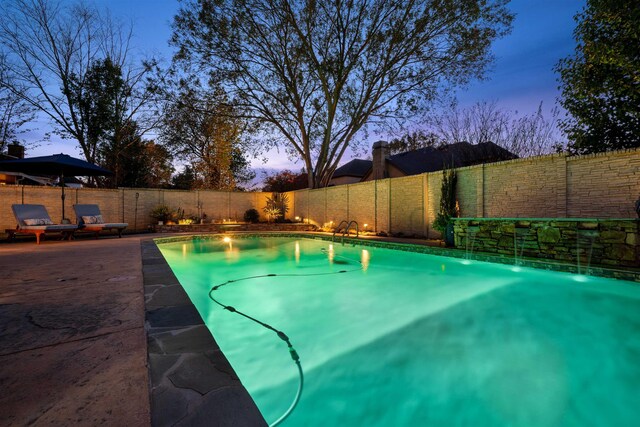 view of pool at dusk