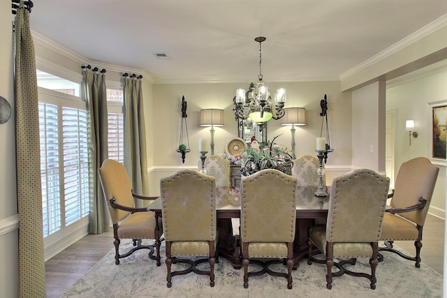 595 Kenrose St, Collierville, TN 38017 - dining area with a chandelier, wood finished floors, ornamental molding, and healthy amount of natural light