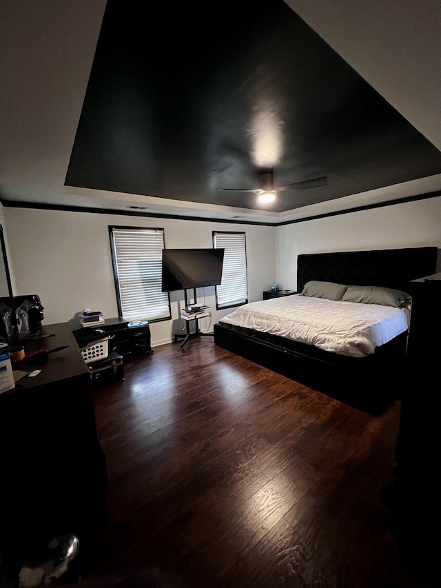 bedroom with ceiling fan and dark hardwood / wood-style floors