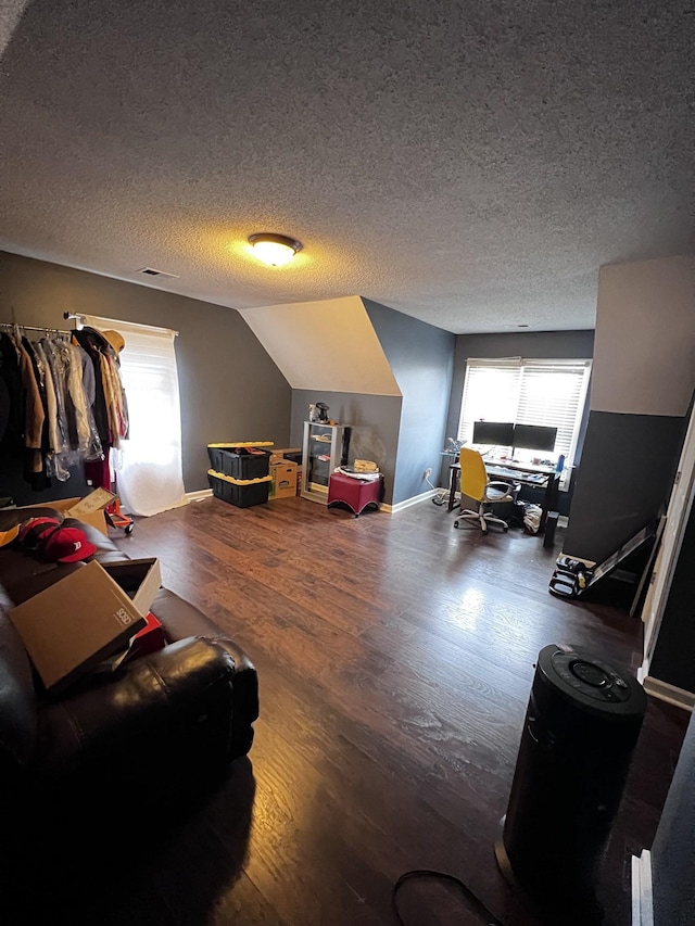 interior space featuring hardwood / wood-style floors, a textured ceiling, vaulted ceiling, and a healthy amount of sunlight