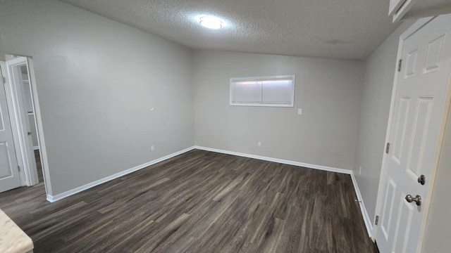 unfurnished bedroom featuring dark wood-type flooring and a textured ceiling