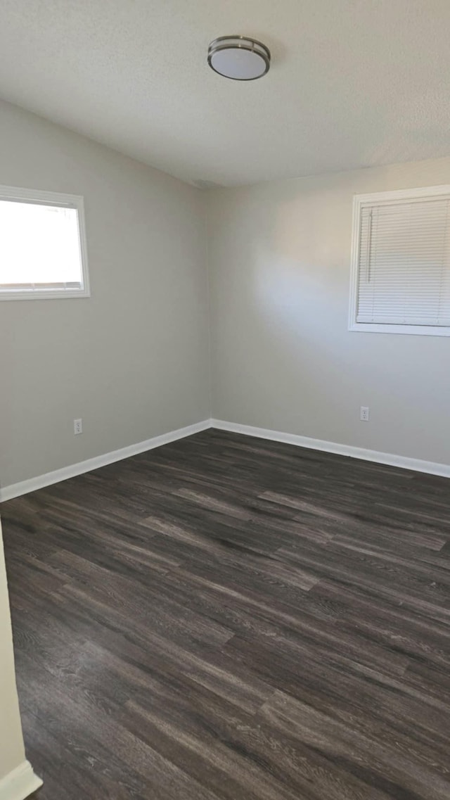 spare room featuring dark hardwood / wood-style flooring