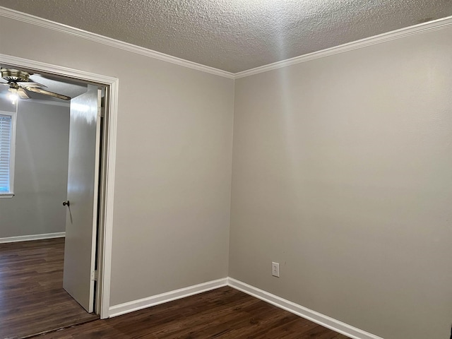 empty room with crown molding, ceiling fan, dark wood-type flooring, and a textured ceiling