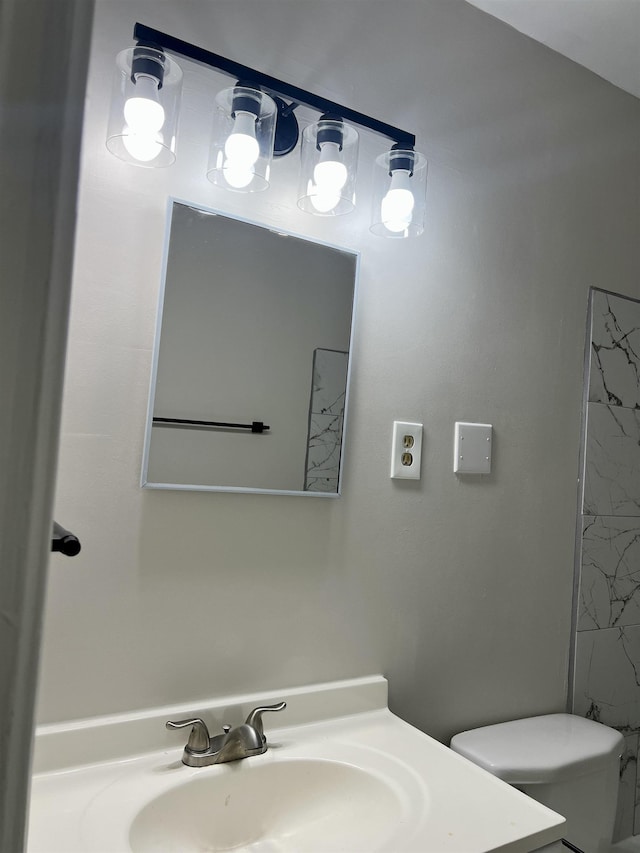 bathroom with a shower, vanity, and toilet