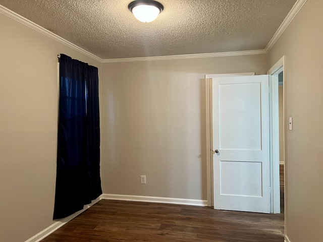 unfurnished room featuring dark wood-type flooring, a textured ceiling, and ornamental molding