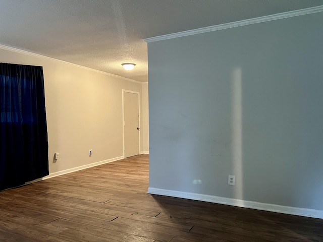 empty room featuring hardwood / wood-style floors, a textured ceiling, and ornamental molding