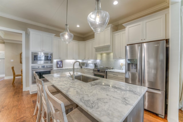 kitchen featuring decorative backsplash, sink, white cabinets, and stainless steel appliances