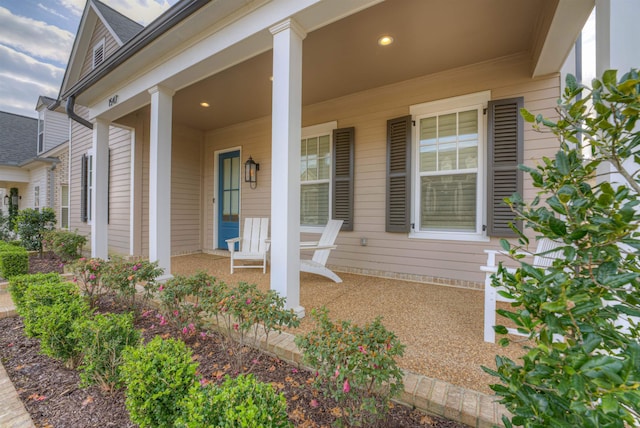 view of exterior entry featuring covered porch