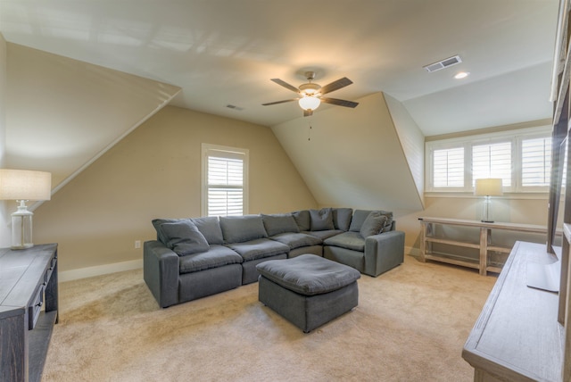 living room with ceiling fan, light carpet, and vaulted ceiling