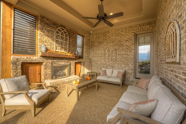 view of patio / terrace with an outdoor living space with a fireplace and ceiling fan