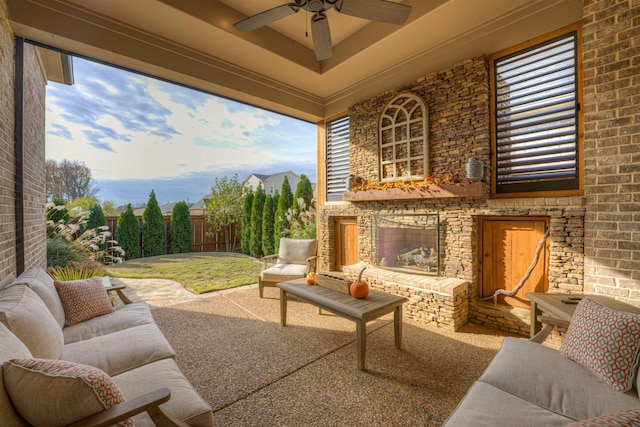 view of patio / terrace featuring ceiling fan and an outdoor brick fireplace