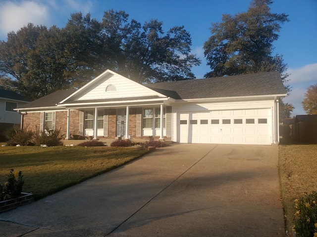 view of front of property with a garage and a front lawn