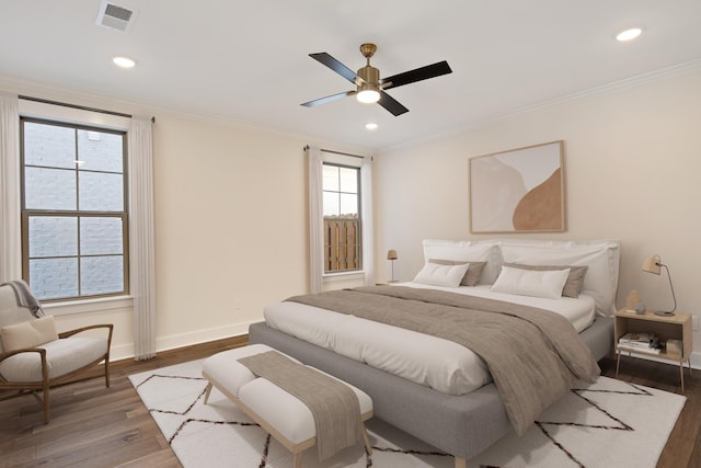 bedroom featuring ceiling fan, dark hardwood / wood-style flooring, and ornamental molding