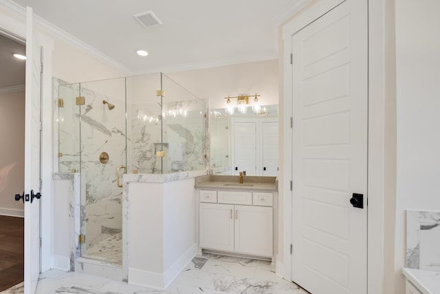 bathroom with vanity, a shower with door, and crown molding