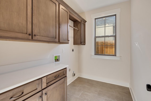 laundry room featuring washer hookup, electric dryer hookup, cabinets, and hookup for a gas dryer