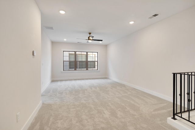 carpeted spare room with ceiling fan