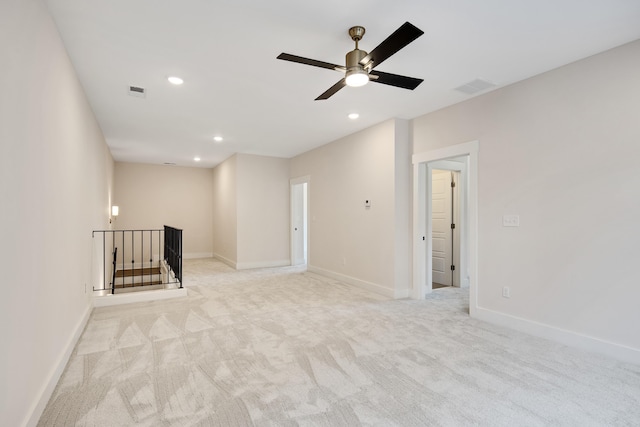 unfurnished living room featuring ceiling fan and light colored carpet