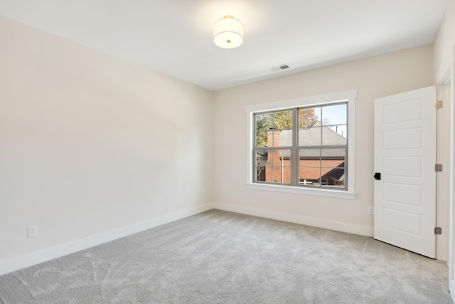 unfurnished room featuring light colored carpet