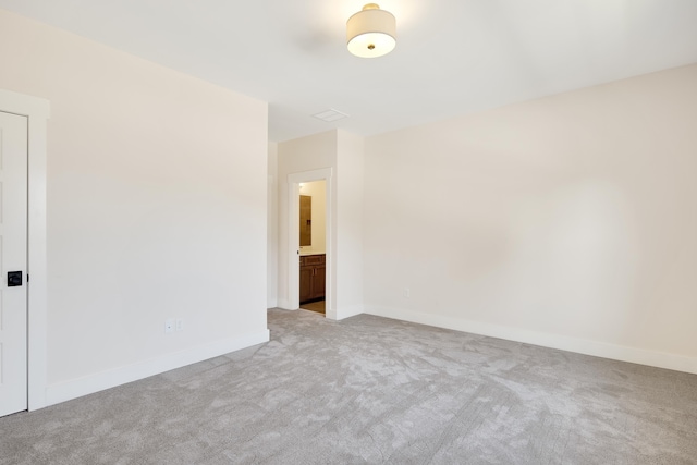 unfurnished room with light colored carpet